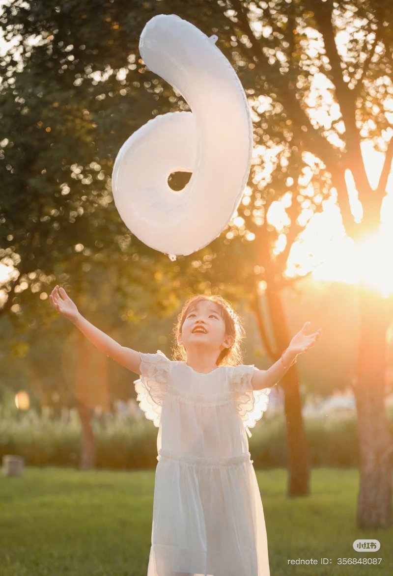 Tạo dáng bé ngồi cạnh "người bạn bóng số mới ” ( Nguồn ảnh: Sưu tầm )