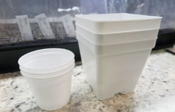 Classic plastic nursery pots come in a range of sizes and colors. These small 2-inch and 4-inch diameter pots are perfect for starting seeds and cuttings. They can be washed and reused or recycled when they’ve run their course. 