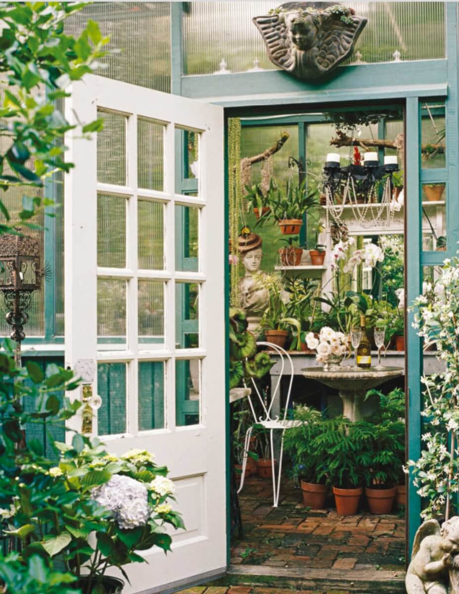 This custom- designed greenhouse has a higher roof than is customary for home greenhouses and plenty of homey touches to make it more livable and pleasing for people. The greenhouse allows room for a small dining table, and the plants become objets d’art.