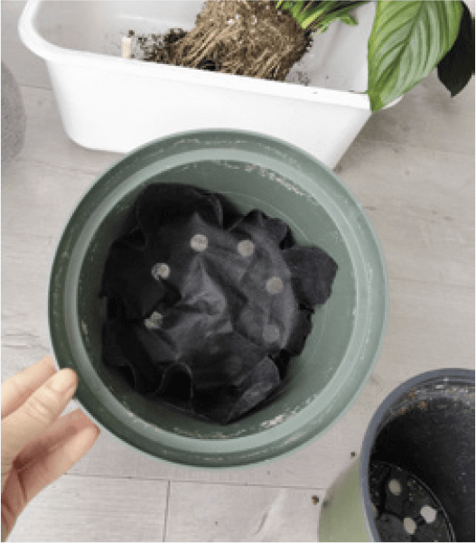 5. Cover the drainage hole with a piece of landscape fabric instead of a piece of broken clay pot. Just buy yourself one roll, and it should last you several years of plant parenthood. It’s cheap, lets water through, and who has pieces of broken clay pots lying around?